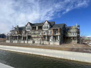 View of front of home with a water view