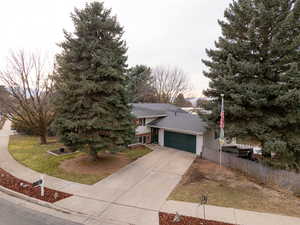 View of front of home featuring a front yard and a garage