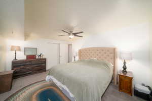 Bedroom featuring ceiling fan, a closet, and light colored carpet