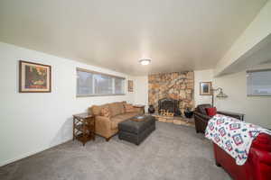 Carpeted living room with a fireplace and a textured ceiling