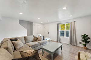 Living room featuring a textured ceiling and light wood-type flooring