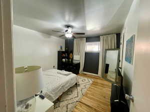 Bedroom featuring ceiling fan and light hardwood / wood-style flooring