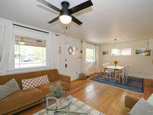 Living room with wood-type flooring and ceiling fan