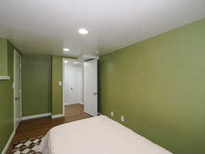 Bedroom with dark wood-type flooring