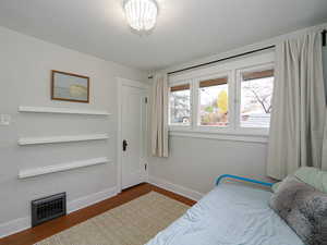 Bedroom with hardwood / wood-style flooring