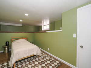 Bedroom with wood-type flooring