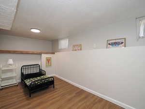 Bedroom featuring a textured ceiling and hardwood / wood-style flooring