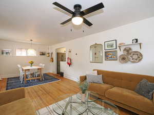 Living room with hardwood / wood-style flooring and ceiling fan