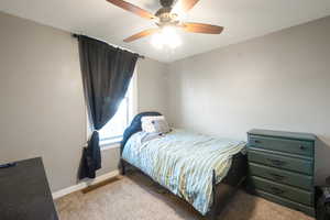 Bedroom featuring light carpet and ceiling fan