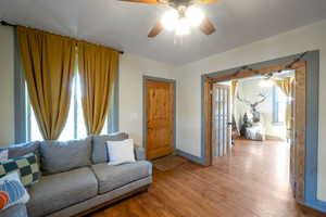 Living room featuring light hardwood / wood-style floors and ceiling fan