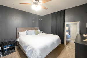 Carpeted bedroom with ceiling fan