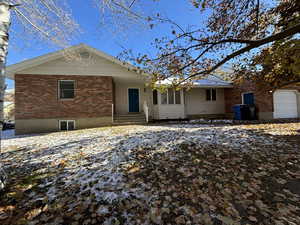 Rear view of house featuring a garage