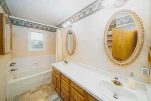 Bathroom with vanity and a bathing tub