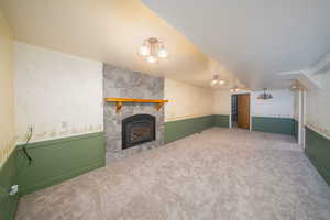 Unfurnished living room featuring a fireplace and carpet floors