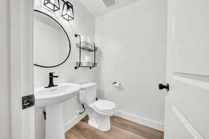 Bathroom featuring hardwood / wood-style floors and toilet