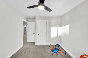 Playroom with ceiling fan and light carpet