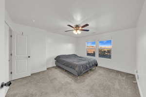 Carpeted bedroom featuring ceiling fan