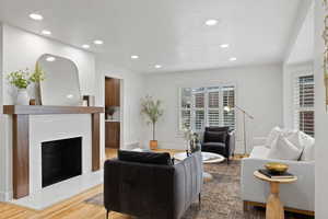 Living room featuring hardwood / wood-style floors and a high end fireplace