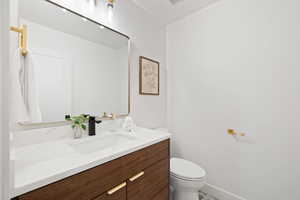 Bathroom featuring vanity and toilet