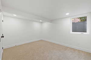 Unfurnished room featuring light colored carpet