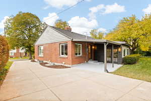 Rear view of property with a lawn