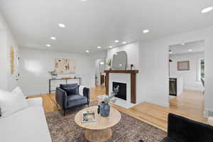 Living room featuring hardwood / wood-style flooring and a premium fireplace