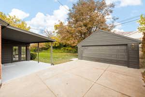 Garage featuring french doors and a lawn