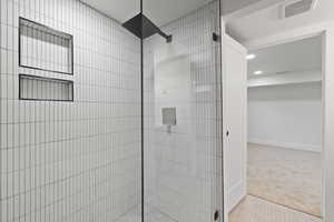 Bathroom featuring a tile shower