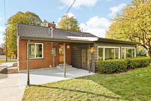 Back of property featuring a lawn and french doors