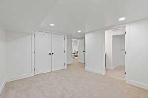 Unfurnished bedroom featuring light carpet and a closet