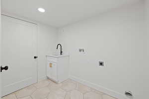 Laundry room with cabinets, washer hookup, electric dryer hookup, sink, and light tile patterned floors