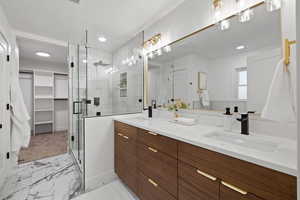 Bathroom featuring vanity and a shower with door