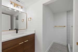 Bathroom with a tile shower and vanity