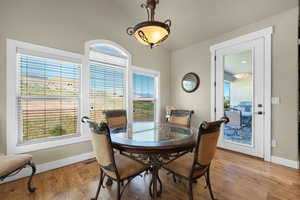 Dining room featuring vaulted ceiling and light hardwood / wood-style flooring