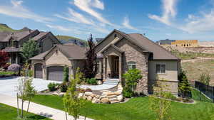 French provincial home featuring a garage and a front lawn