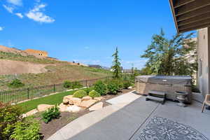 View of patio / terrace featuring a mountain view and a hot tub