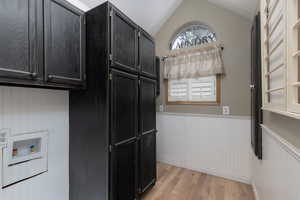 Kitchen featuring light wood-type flooring and lofted ceiling