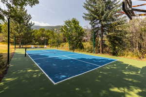 View of sport court featuring basketball hoop and a mountain view