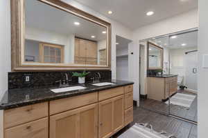 Bathroom featuring tasteful backsplash, hardwood / wood-style floors, an enclosed shower, toilet, and vanity