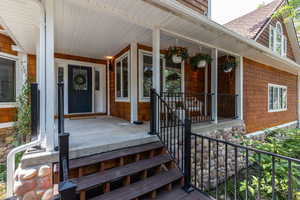 View of exterior entry with covered porch