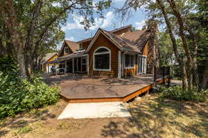 Rear view of property featuring a deck