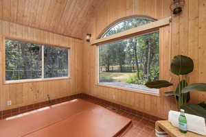 Unfurnished sunroom with lofted ceiling and wooden ceiling