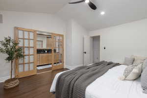 Bedroom featuring ceiling fan, dark wood-type flooring, and lofted ceiling