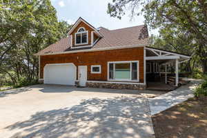 View of front of house featuring a porch and a garage