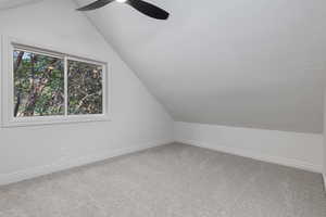 Bonus room with carpet flooring, ceiling fan, and lofted ceiling