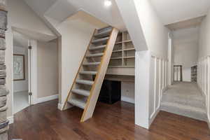 Stairway with hardwood / wood-style floors and built in desk