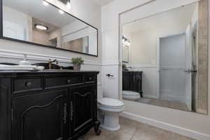 Bathroom with tile patterned floors, vanity, and toilet