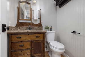 Bathroom with vanity, wood-type flooring, and toilet