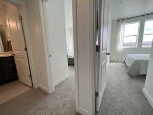 Hallway with light colored carpet