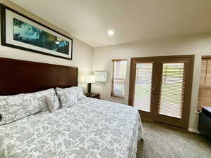 Bedroom featuring access to outside, light colored carpet, baseboards, and recessed lighting